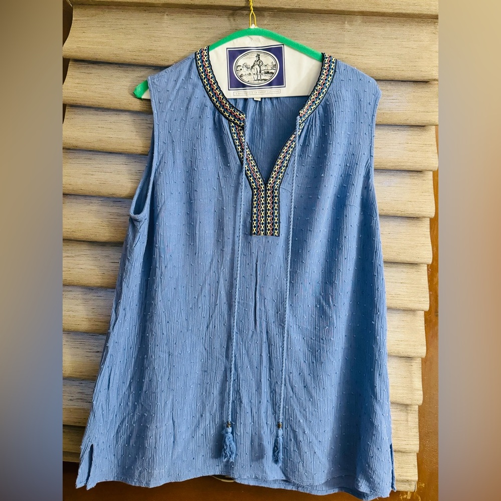 Sleeveless top with embroidered neckline.